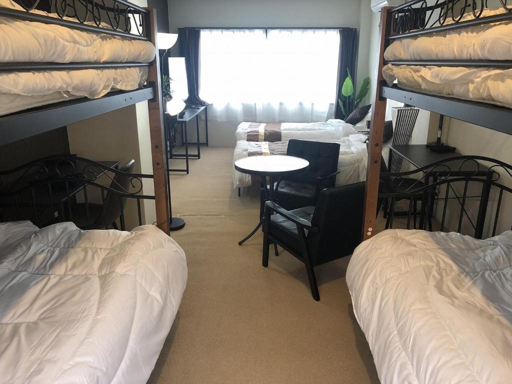 Postel nebo postele na pokoji v ubytování Cool-inn Otaru