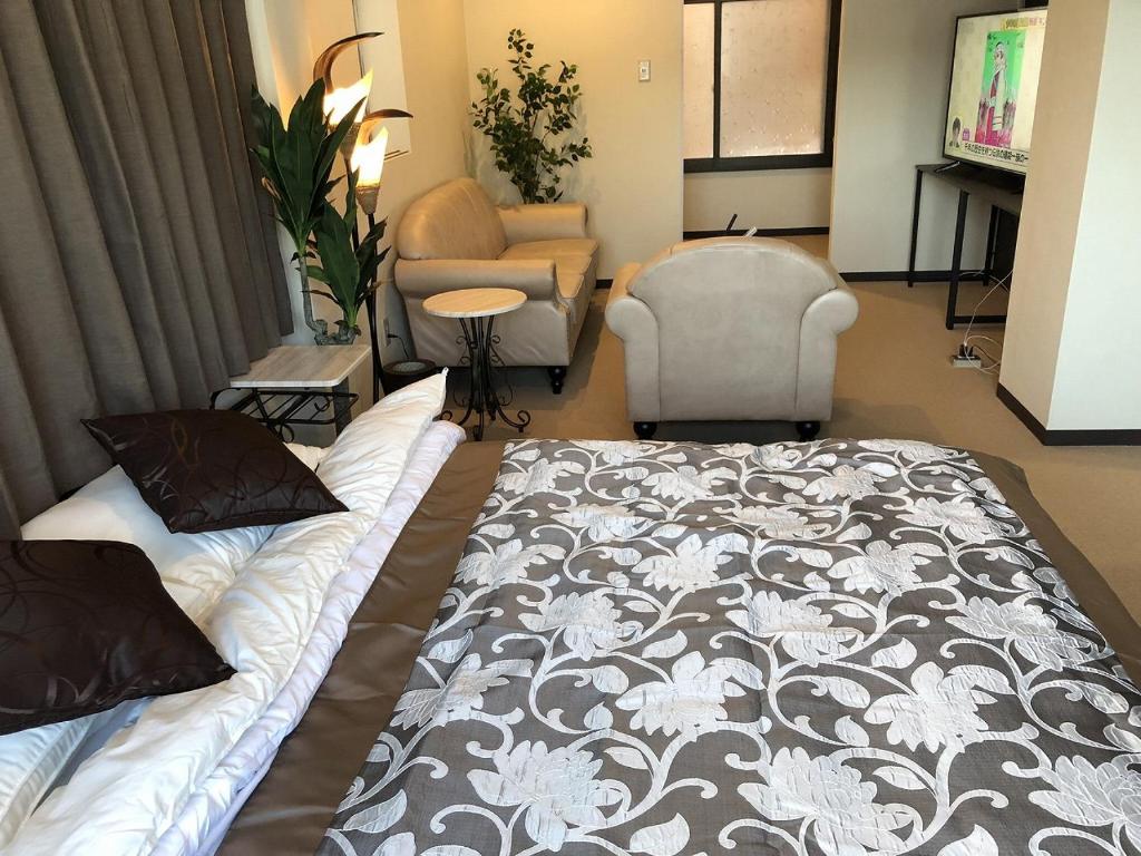Postel nebo postele na pokoji v ubytování Cool-inn Otaru