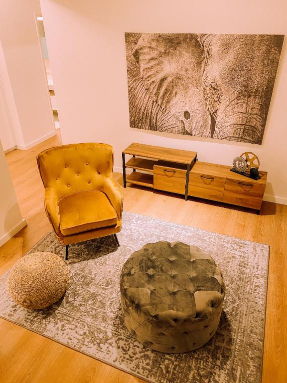 a living room with a chair and a table at Newly Renovated Super-Chic Apartment in Nicosia