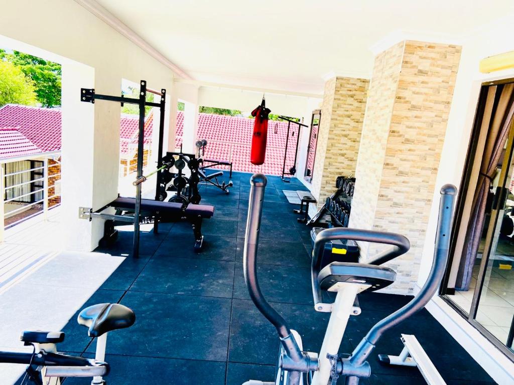 a gym with two bikes parked in a room at C&C HOTEL VIBES Randpark Ridge JHB 14 Units Available in Boskruin