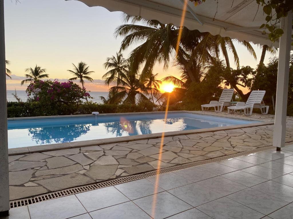 - une piscine dans une villa au coucher du soleil dans l'établissement Villa de 2 chambres avec vue sur la mer piscine privee et jacuzzi a Saint Pierre a 1 km de la plage, à Saint-Pierre