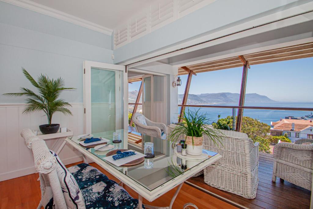 a dining room with a view of the ocean at A Boat House in Simonʼs Town