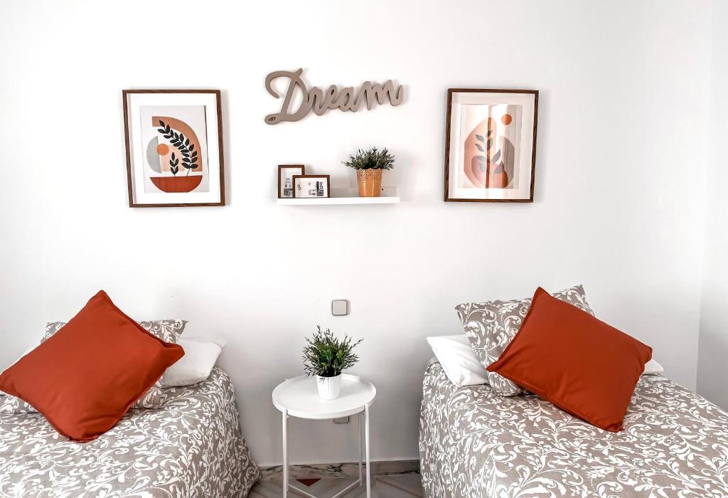 a bedroom with two beds and a sign on the wall at Zoronga home in Las Navas del Marqués