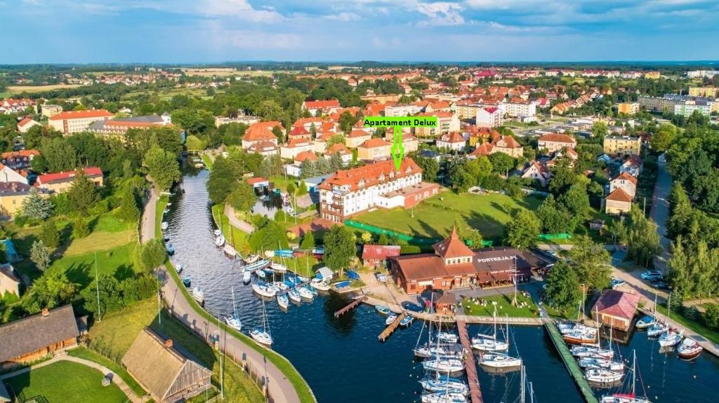 an aerial view of a town with boats in a harbor at Apartament Żeglarski Vęgoria Deluxe z widokiem na Port in Węgorzewo
