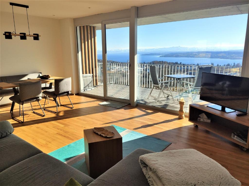 a living room with a couch and a television at Hecklers Seepanorama Appartements in Überlingen