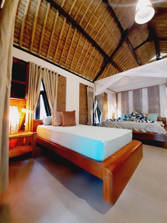 1 Schlafzimmer mit 2 Betten in einem Zimmer in der Unterkunft JEJU Cottages in Kuta Lombok