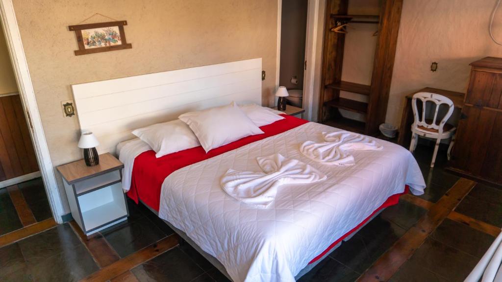Uma cama ou camas num quarto em Aardvark Inn Pousada