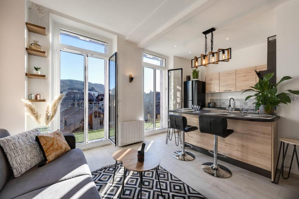 uma sala de estar com um sofá e uma cozinha em Le Balcon Annécien 4 - rooftop view for 2-4 people em Annecy