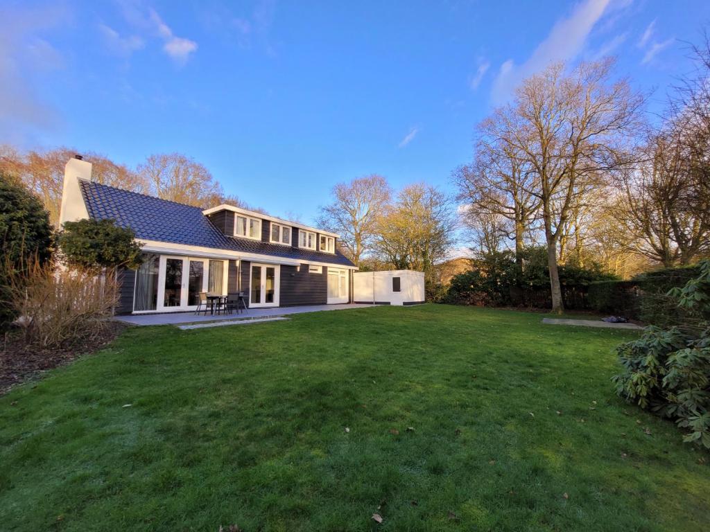 a house with a large lawn in front of it at De Egel in Oostkapelle