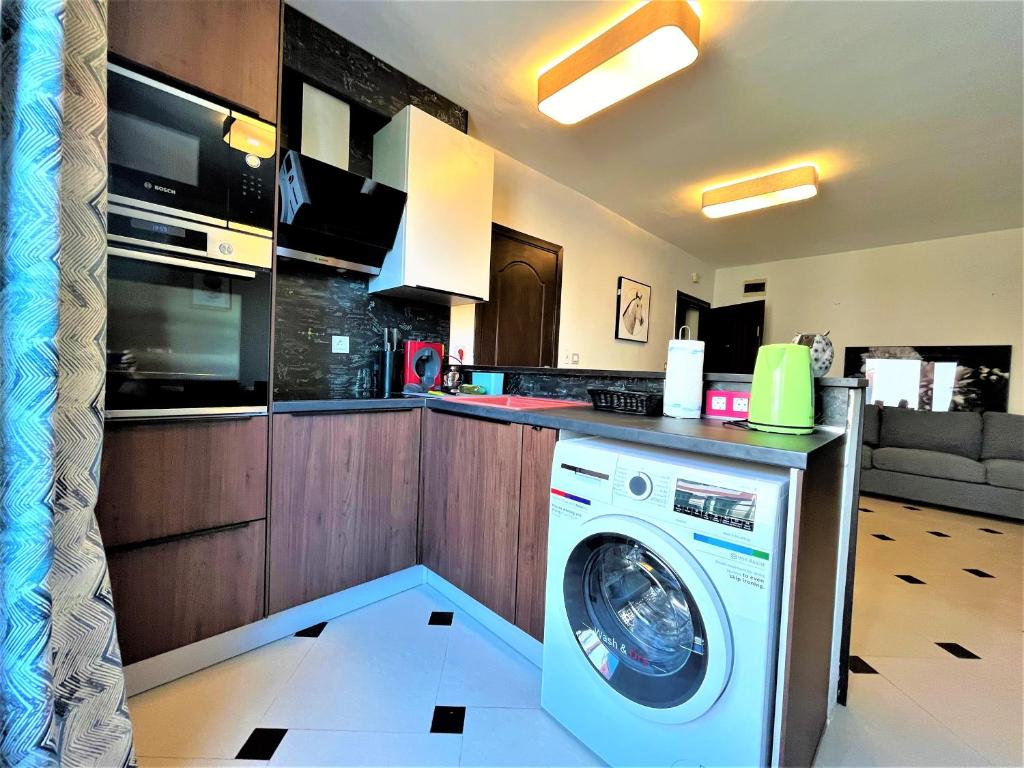 a kitchen with a washing machine in a kitchen at Botabara 312 Self Catering Beach Apartment in Pomorie