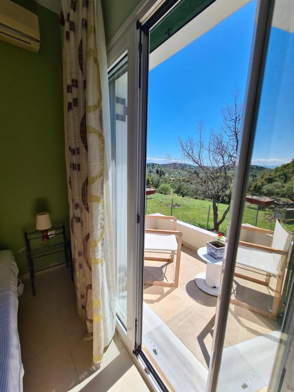 a room with a sliding glass door leading to a patio at Irini&#39;s country house in Gouvia