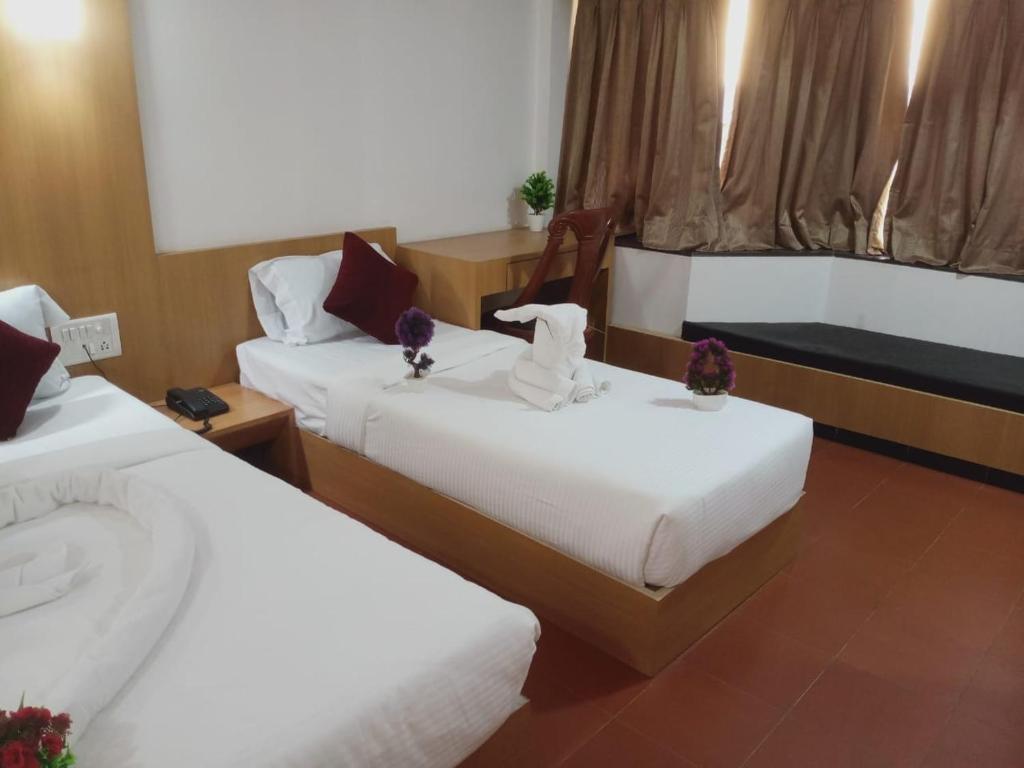 Postel nebo postele na pokoji v ubytování Hotel Kewal