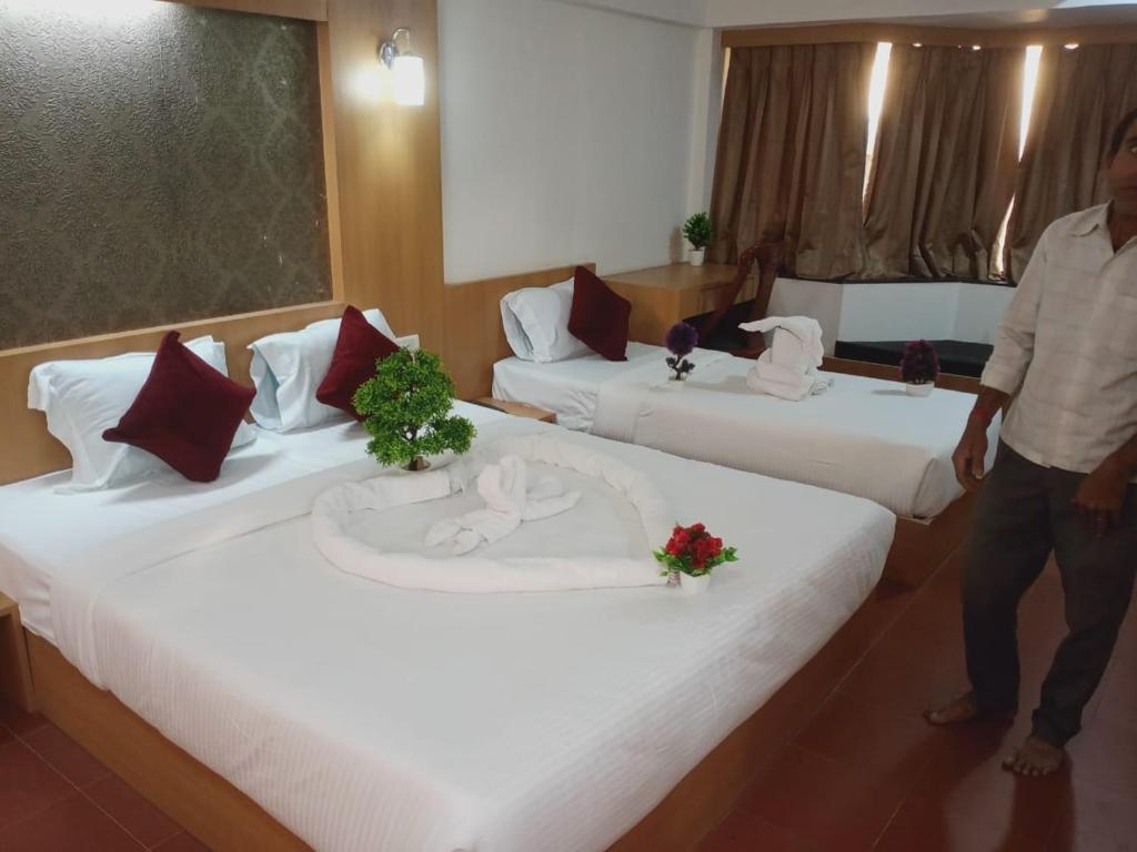 Postel nebo postele na pokoji v ubytování Hotel Kewal