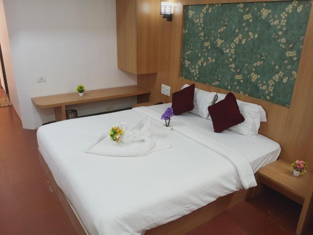 Postel nebo postele na pokoji v ubytování Hotel Kewal