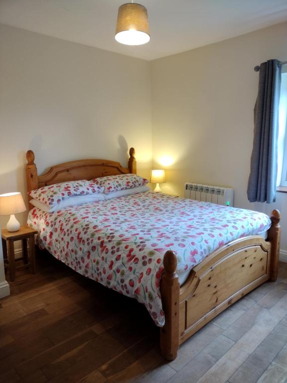 a bedroom with a wooden bed in a room at Rosedene in Mablethorpe