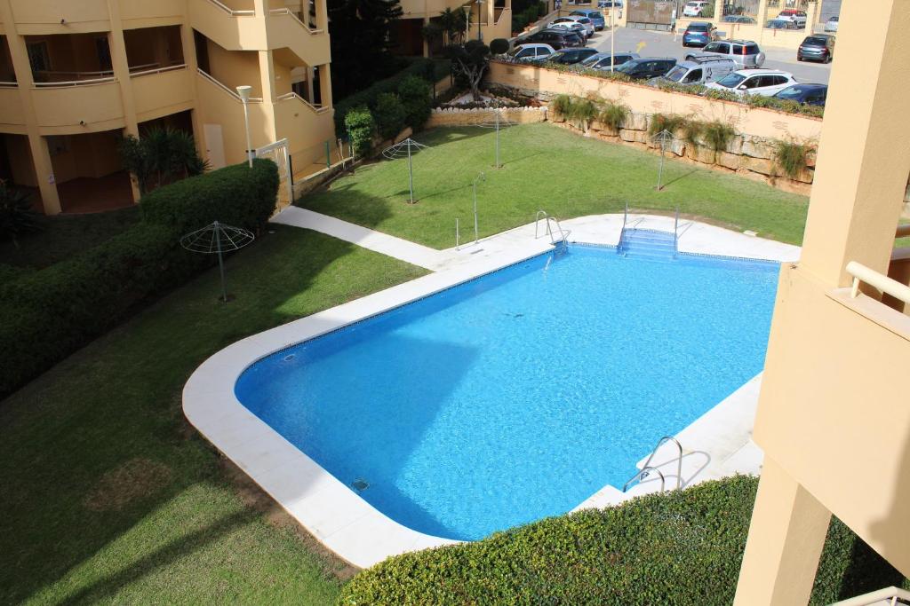 an overhead view of a large swimming pool in a yard at BEACH FOREST PARADISE in Cabopino