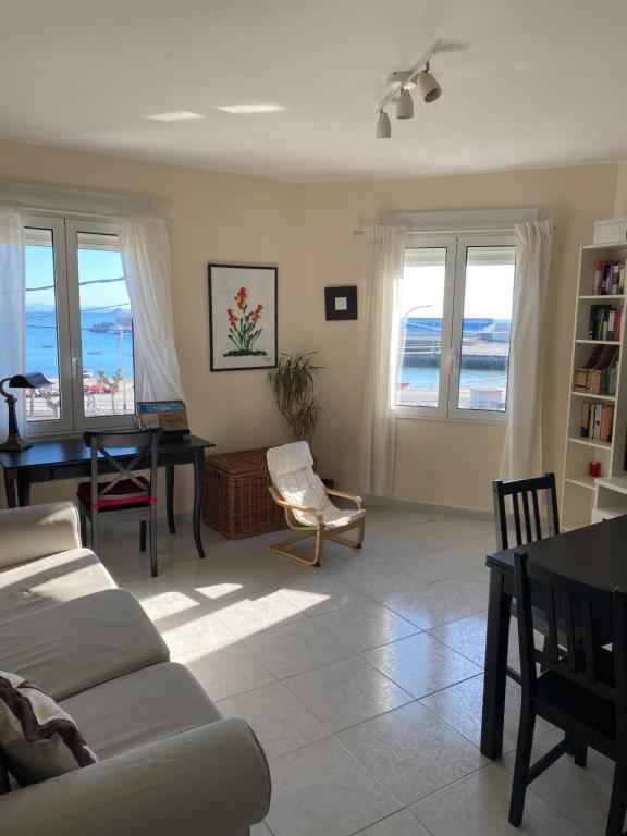 a living room with a view of the ocean at Apartamento en las Rias Bajas in Ribeira