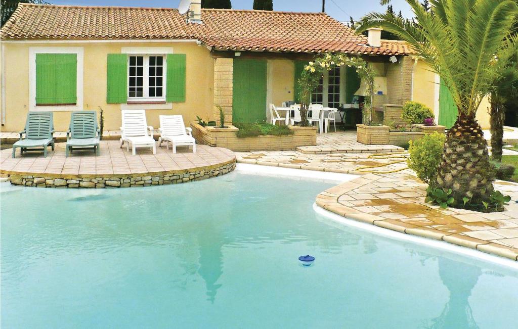 a swimming pool in front of a house at 3 Bedroom Beautiful Home In Boulbon in Boulbon