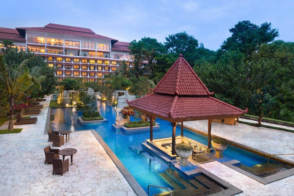 a hotel room with a pool and a pool table at Sheraton Mustika Yogyakarta Resort and Spa - CHSE Certified in Yogyakarta