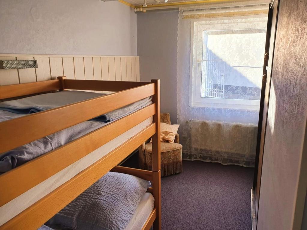 a bedroom with two bunk beds and a window at Ferienwohnung Daliah in Wangels