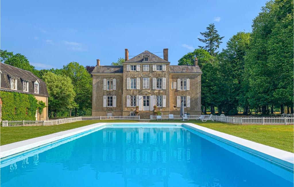 a large house with a swimming pool in front of it at Lovely Home In St Michel D,chavaignes With Outdoor Swimming Pool in Thorigné-sur-Dué