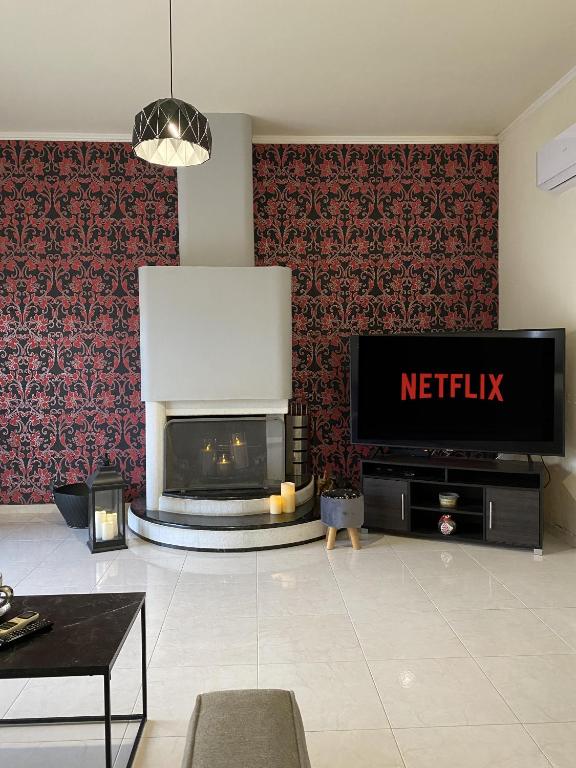 Televízia a/alebo spoločenská miestnosť v ubytovaní Eva's Garden House