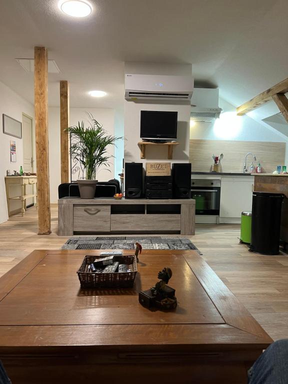 ein Wohnzimmer mit einem Sofa und einem Tisch in der Unterkunft Gîte cedric in Reiningue