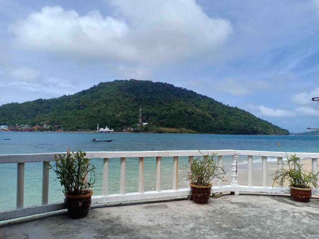 a balcony with a view of the ocean and a mountain at Suhaila Palace in Perhentian Islands
