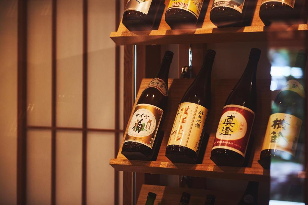 a bunch of bottles of wine on a shelf at Sui Suwako in Suwa