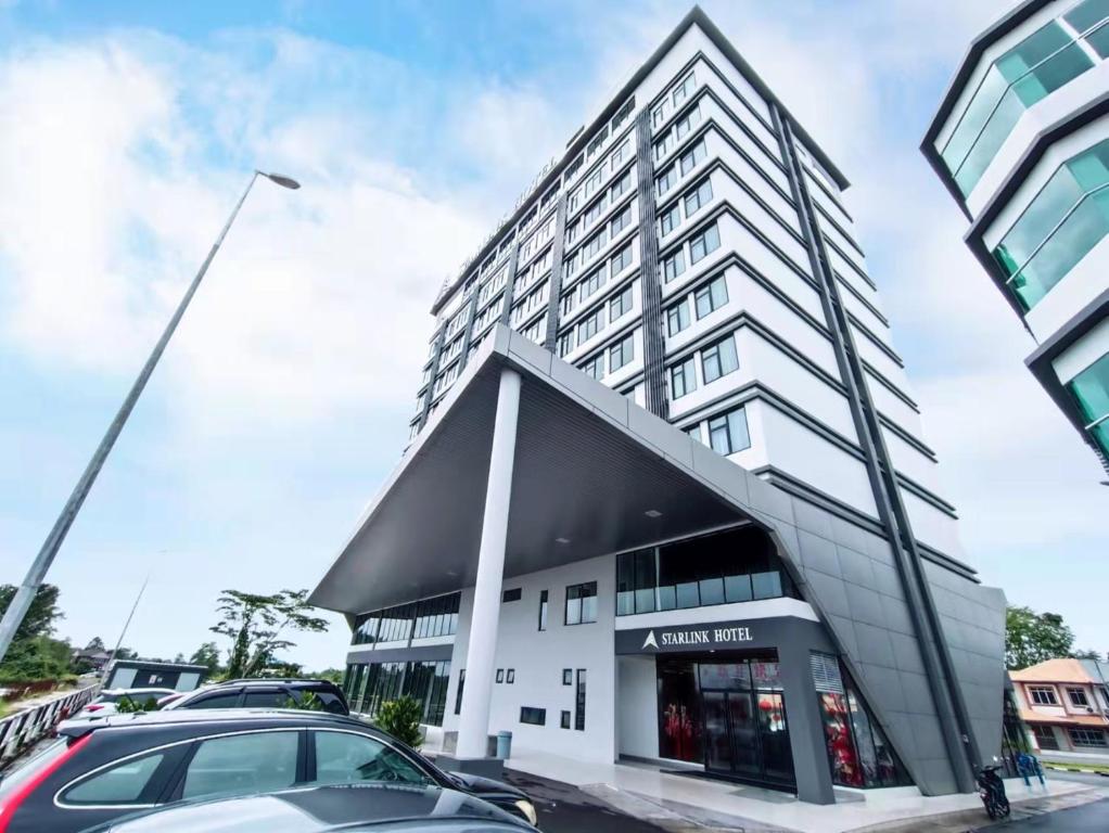 a building with a car parked in front of it at Starlink Hotel in Sibu