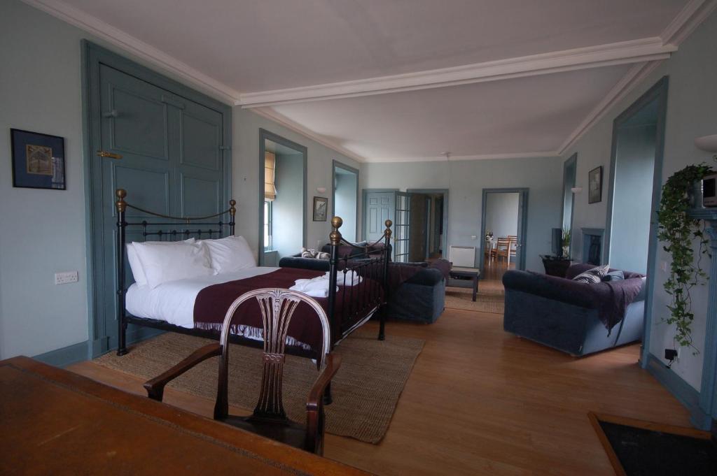 a bedroom with a bed and a living room at High St Flat in Edinburgh