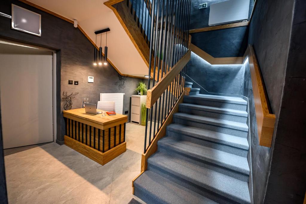 a staircase in a house with a desk at Wójcik SPA - Krynica Zdrój in Krynica Zdrój