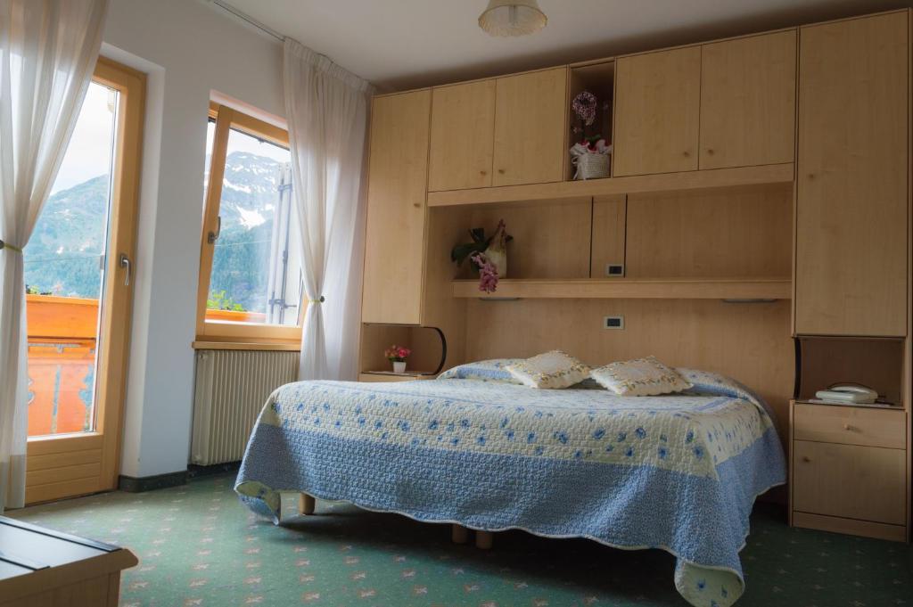 Postel nebo postele na pokoji v ubytování Hotel Garni Excelsior
