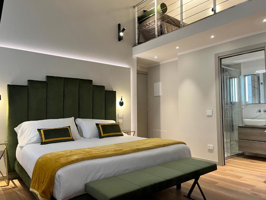 a bedroom with a large bed with a green headboard at Corte dei Sogni Boutique Hotel & spa in Florence