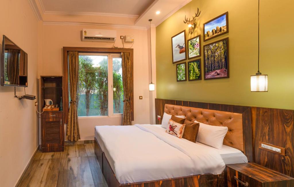 a bedroom with a large bed and a window at Srina Forest Roar, Corbett- Near Pick up point in Rāmnagar