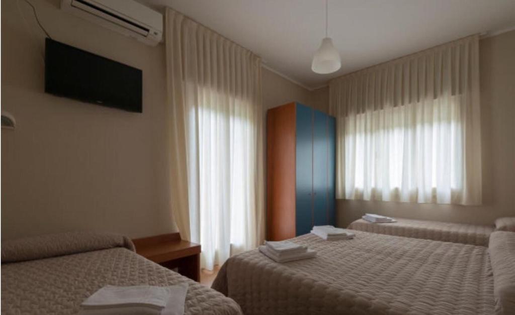 Postel nebo postele na pokoji v ubytování Hotel President