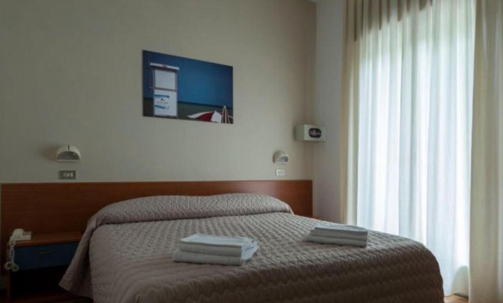 Postel nebo postele na pokoji v ubytování Hotel President
