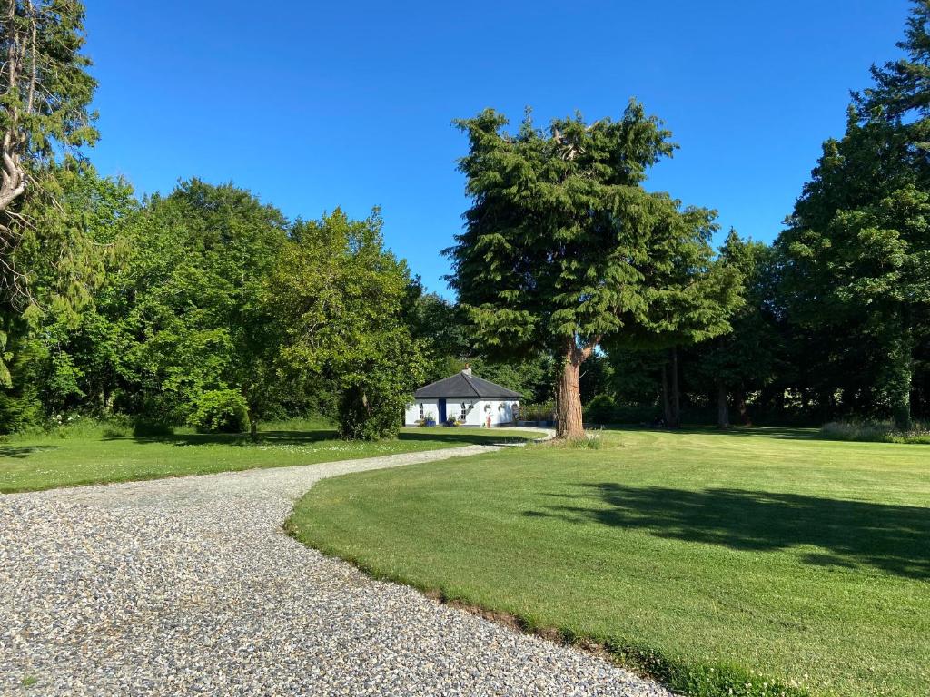 a gravel road leading to a house in a park at Rathjarney Gatelodge in Wexford