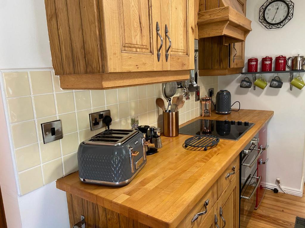 a kitchen counter with a toaster on top of it at Rathjarney Gatelodge in Wexford