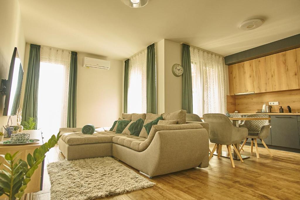 a living room with a couch and a kitchen at SUNLIGHT SILVER Szeged - Exclusive in Szeged