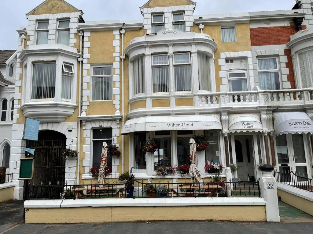 un bâtiment avec des tables et des chaises devant lui dans l'établissement The Wilton Hotel, à Blackpool