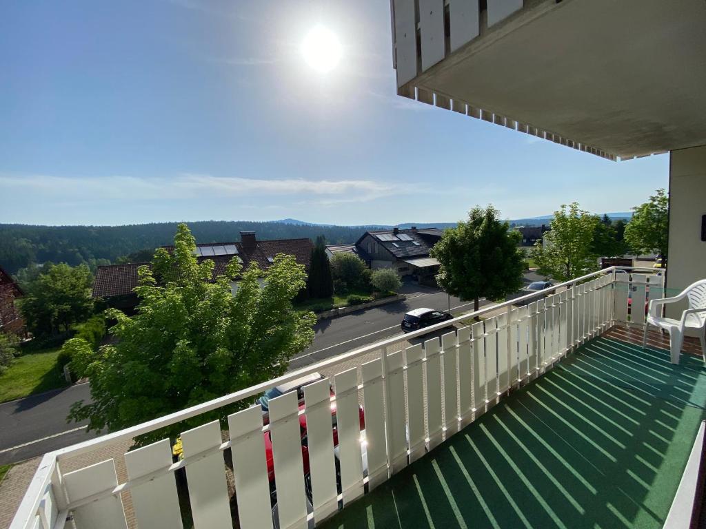 a balcony with a white fence and a street at Wunderschöne Ferienwohnung in Nagel am See in Nagel