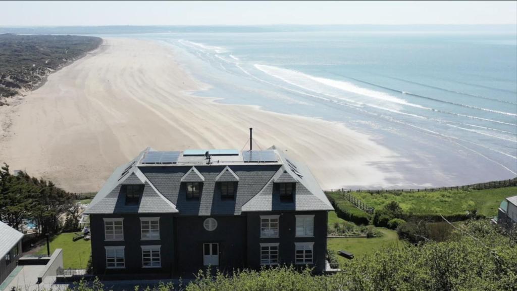 an aerial view of a house next to the beach at Chalet Saunton in Braunton