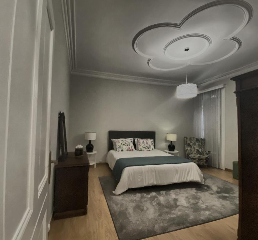 a bedroom with a bed and a large ceiling at Além do Mar Apartment - RRAL n. 3214 in Ribeira Grande