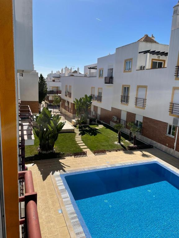 a swimming pool in front of a building at Dream Holidays Cabanas in Tavira