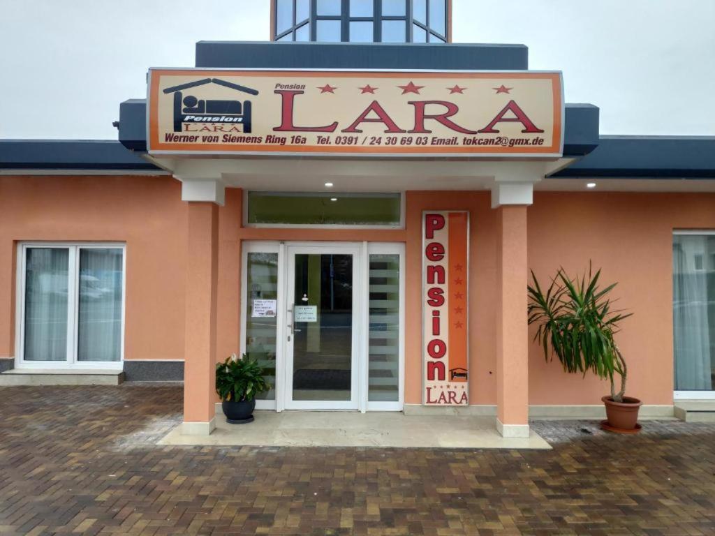 a building with a sign that reads larma at Pension Lara in Magdeburg