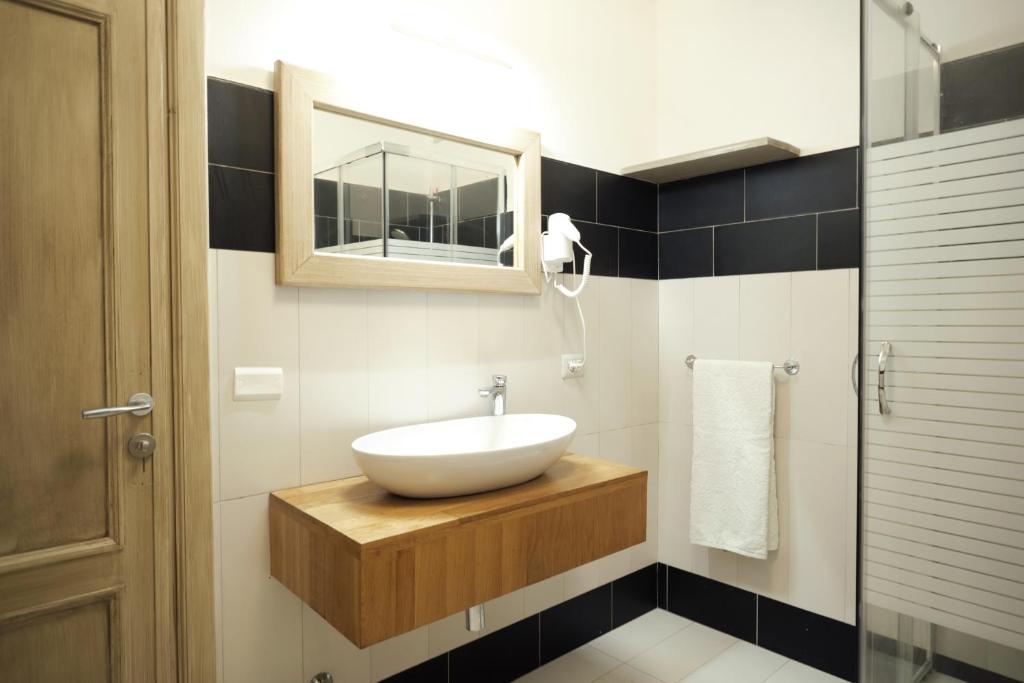 a bathroom with a sink and a mirror at HOTEL CAMPO STELLA in Leonessa