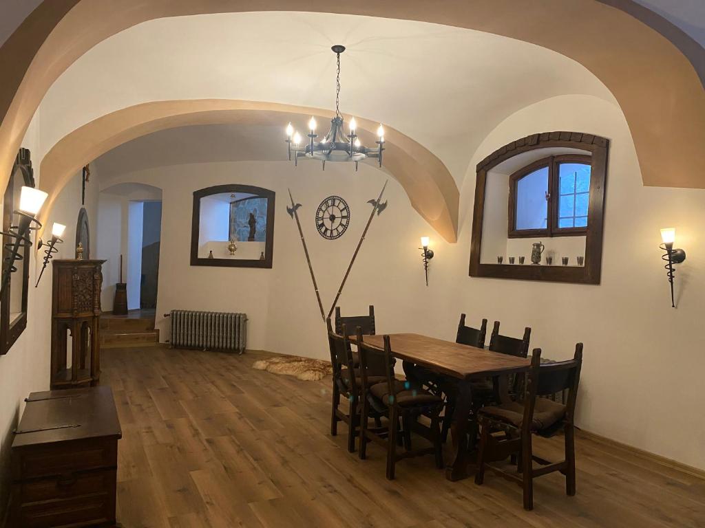 a dining room with a table and chairs at SUPERB - Medieval apartment in Kutná Hora
