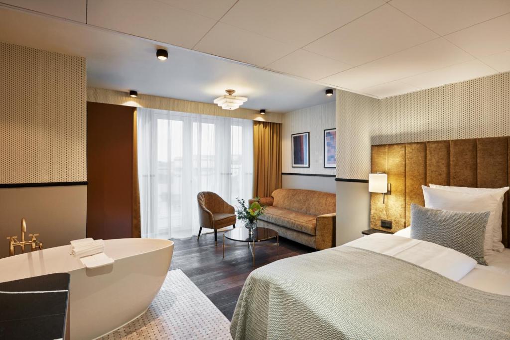 a hotel room with two beds and a television at WIDE Hotel in Copenhagen