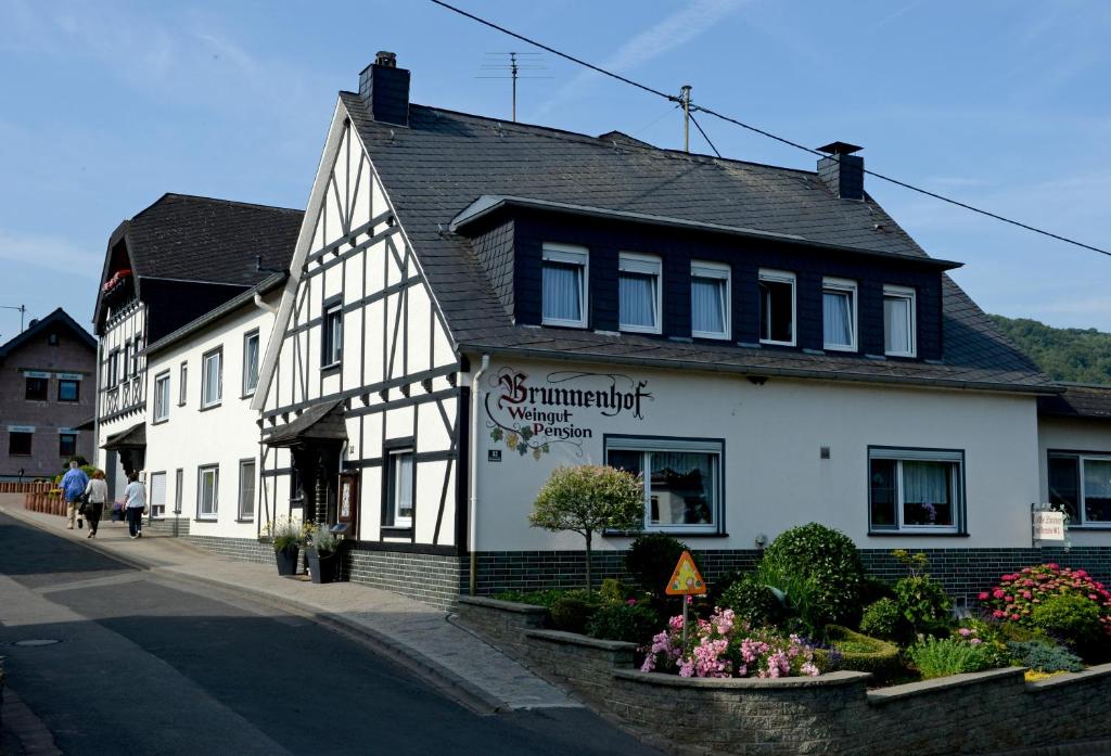 a white building on the side of a street at Brunnenhof in Bruttig-Fankel